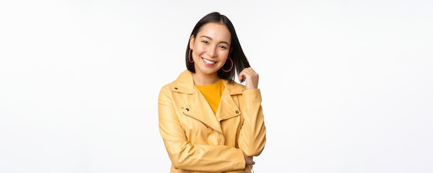 Asian Woman in Yellow Jacket Smiling Against White Background – Free Download