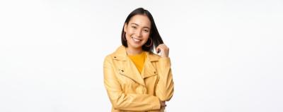 Asian Woman in Yellow Jacket Smiling Against White Background – Free Download