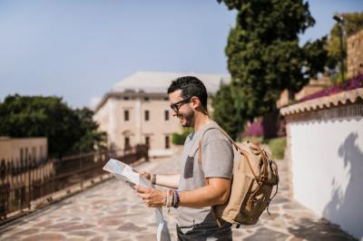 Smiling Man Looking at Map on Street – Free Stock Photo, Download Free