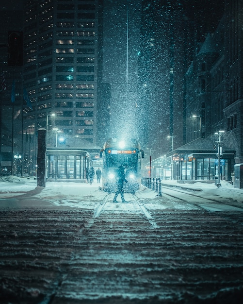 Person Standing in Front of Train on a Snowy Road – Free Download