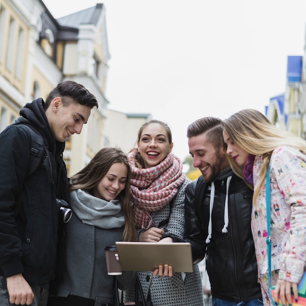 Explore the City: Tourists Using Digital Tablet on Street – Free Download