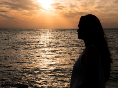 Beautiful Woman Admiring the Sunset at the Sea – Free Download