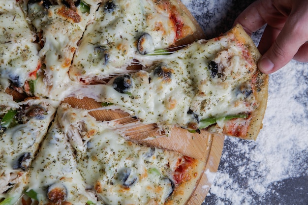 Close-Up of a Delicious Pizza on a Wooden Stand – Free Stock Photo, Download for Free