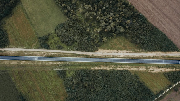 Aerial Shot of a Road Under Construction Surrounded by Cultivated Fields in Brcko District – Free Download