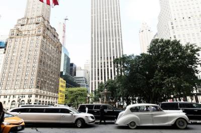 White Retro Car and Limousine Cruising Through the Streets of New York – Free Download