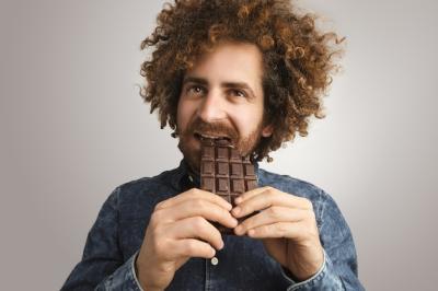 Happy Bearded Man Enjoying a Chocolate Bar – Free Stock Photo, Download for Free