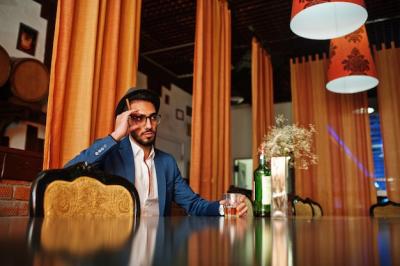 Handsome Well-Dressed Arabian Man Enjoying Whiskey and Cigar at Pub – Free Download