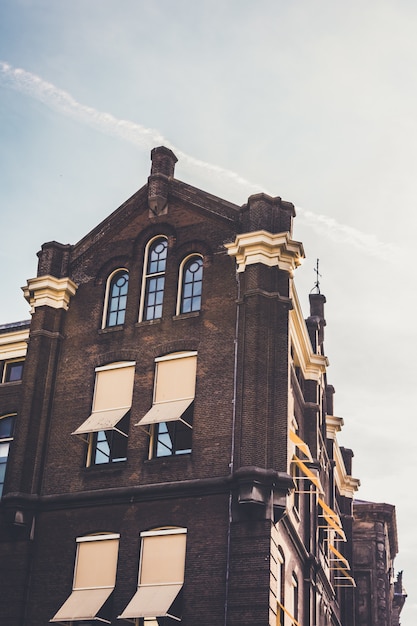 Vertical Low Angle View of a Brown and Beige Building Against a Clear Sky – Free Stock Photo for Download