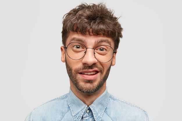 Indecisive and Curious Man with Stubble in Denim Shirt – Free Download