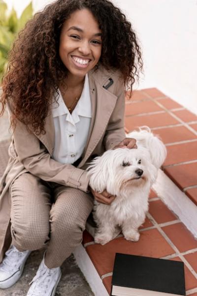 Joyful Woman Playing with Dog by Her Book – Free Download