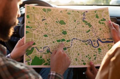 Man and Woman Checking a Map in the Car – Free Download