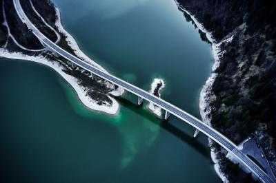 Breathtaking High Angle Shot of a Highway Above Turquoise Water – Free Download