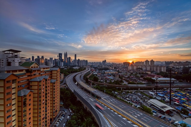 Street View at Sunset: A High Angle Perspective Amidst Buildings – Free Download