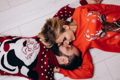 Christmas Sweater Love: Man and Woman Hugging on the Floor – Free Download