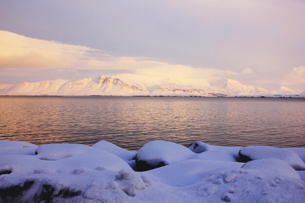 Scenic View of Snowcapped Mountains by the Sea Against the Sky – Free Download