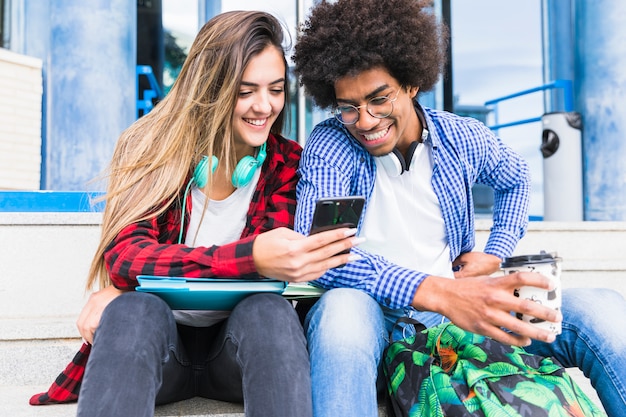 Portrait of Smiling Diverse Young Students with Mobile Phone – Free Stock Photo for Download