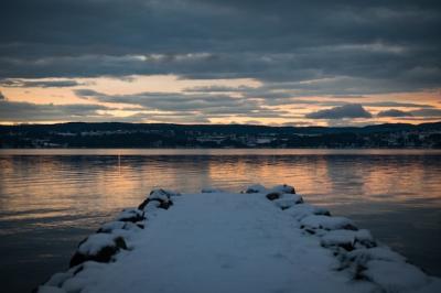 Snow-Covered Dock by the Sea Reflecting the Sunset – Free Download