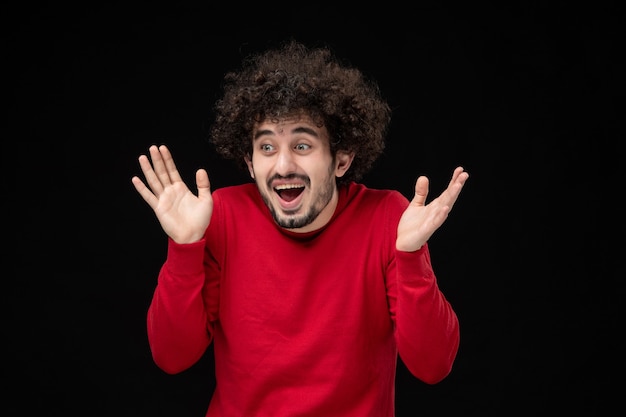 Young Male in Red Sweater Against Black Wall – Free Stock Photo, Download for Free