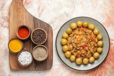 Roasted Eggplant Salad and Pickled Plums with Spices on Cutting Board – Free Stock Photo for Download