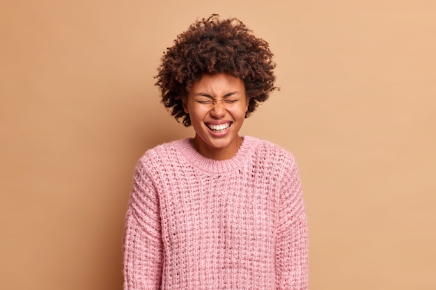 Carefree Woman Laughing with Closed Eyes in Warm Sweater – Free Stock Photo Download