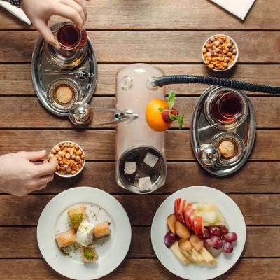 Top View of a Tea Set with Snacks, Sweets, and Fruits – Free Download