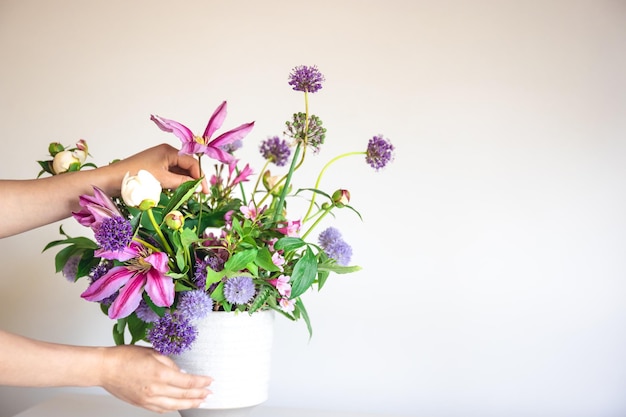 Fresh Summer Flowers in a Vase Held by a Woman Against a White Background – Free Download