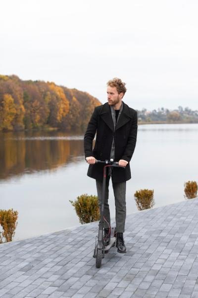 Casual Male Posing with an Electric Scooter – Free Stock Photo for Download