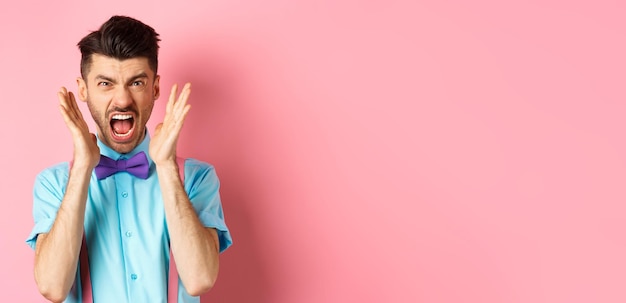 Angry Man Shouting and Displaying Fury Against Pink Background – Free to Download