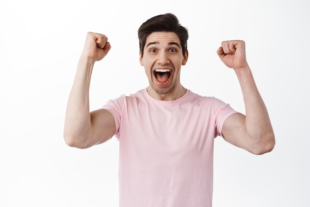 Joyful Celebration of a Man Shaking Hands in Triumph – Free Stock Photo for Download