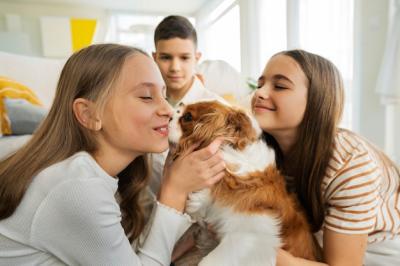 Cousins Enjoying Quality Time at Home with Their Pet Dog – Free Download