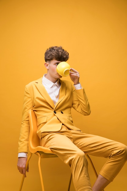 Fashionable Boy Drinking from a Cup – Free Stock Photo for Download