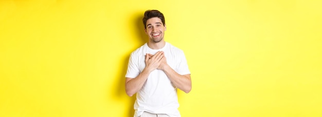 Handsome Guy Smiling with Hands on Heart – Free Stock Photo Download