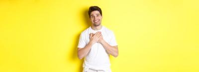 Handsome Guy Smiling with Hands on Heart – Free Stock Photo Download