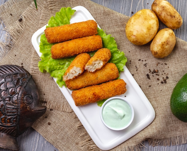 Delicious Top View of Chicken Nuggets on Lettuce with Sauce and Unpeeled Potatoes – Free Download