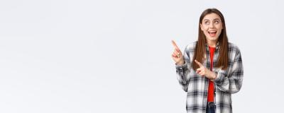 Excited Happy Woman in Checked Shirt Pointing and Smiling – Free Stock Photo for Download