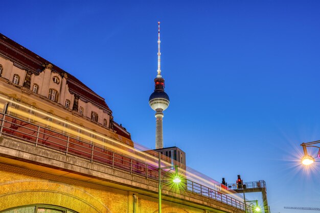 The Iconic TV Tower in Berlin at Dusk with a Motion Blurred Commuter Train – Free Download