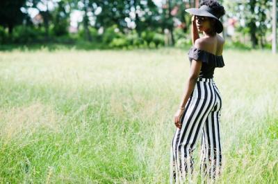 Gorgeous African American Woman in Black and White Stripe Pants Posing in Park