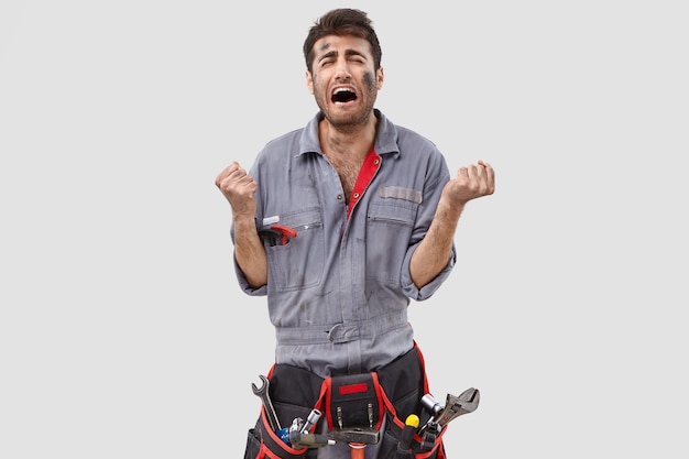 Stressed Handyman Posing Against White Wall – Free Stock Photo, Download Free