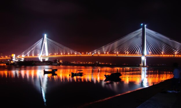 Silhouette Boats on River by Illuminated Bridge at Night – Free to Download