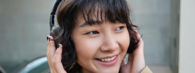 Beautiful Smiling Korean Girl in Headphones Enjoying a Day Out – Free Stock Photo for Download