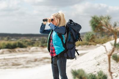 Adult Woman Using Binoculars Outdoors – Free Download