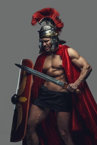 Male Model in Gladiator Pose with Sword and Shield – Free Stock Photo for Download