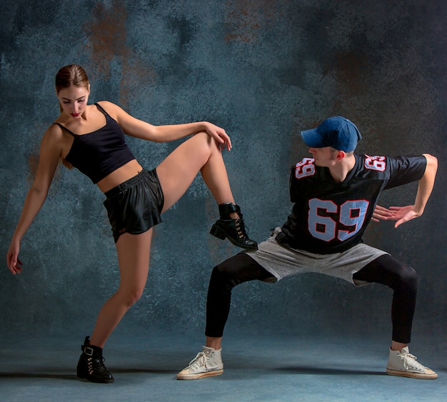 Young Boy and Girl Dancing Hip Hop with a Blue Background – Free Download