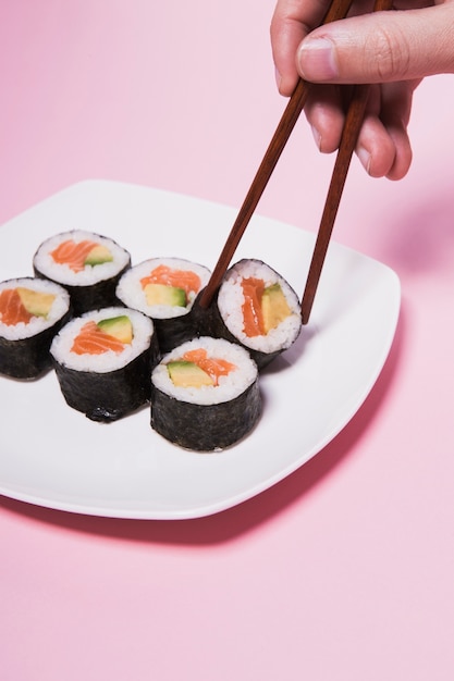 Hand Holding Sushi with Chopsticks – Free Download