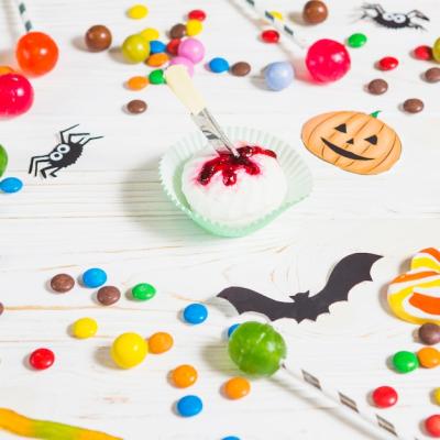 Mini Muffin Surrounded by Candies and Halloween Treats – Free Download