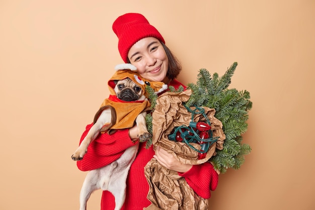 Brunette Woman Celebrates Christmas with Pug Dog and Festive Decor – Free Download