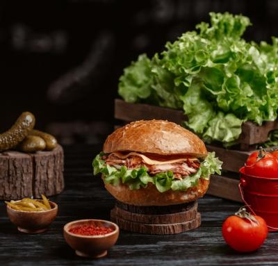 A Delicious Burger with Turshu and Sumakh on a Rustic Table – Free Stock Photo, Download for Free