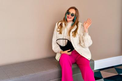 Trendy Blonde Woman Posing in Luxury Hotel with Warm Colorful Outfit – Free Download