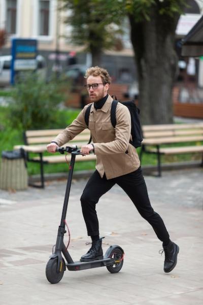 Casual Male Riding an Electric Scooter – Free Download