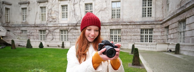 Happy Redhead Girl Tourist Taking Photos with a Professional Camera – Free Download